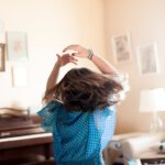 girl twirling around room